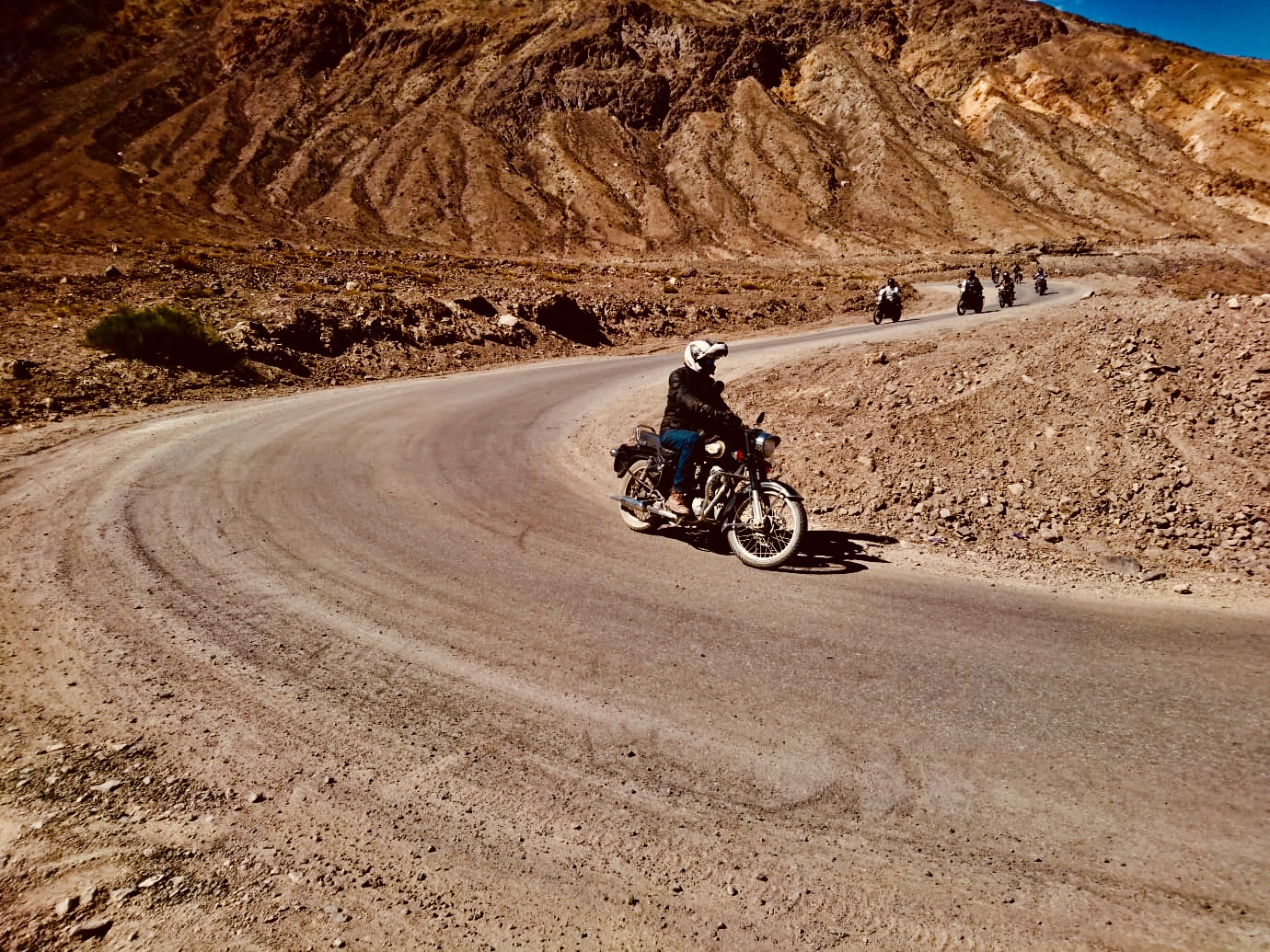 Bike riders riding bikes through the cold desert of Nubra Valley I A thrilling Ladakh Motorcycle Tour on Royal Enfield, 2023