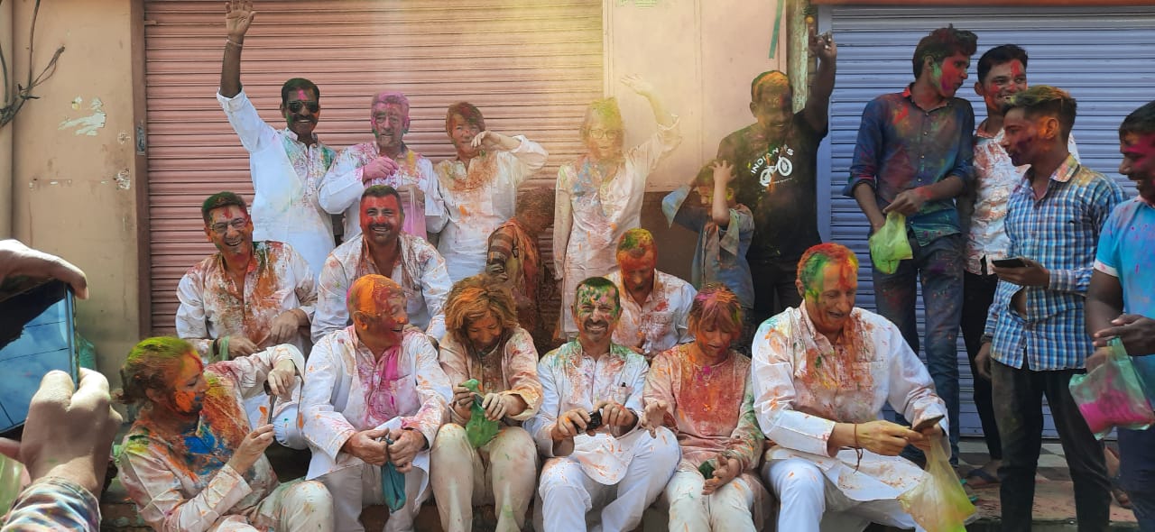 A Group of foreign tourists enjoying the Festival of Colors with Locals I Enjoy the  "Festivals Of India Tour on a Motorbike"