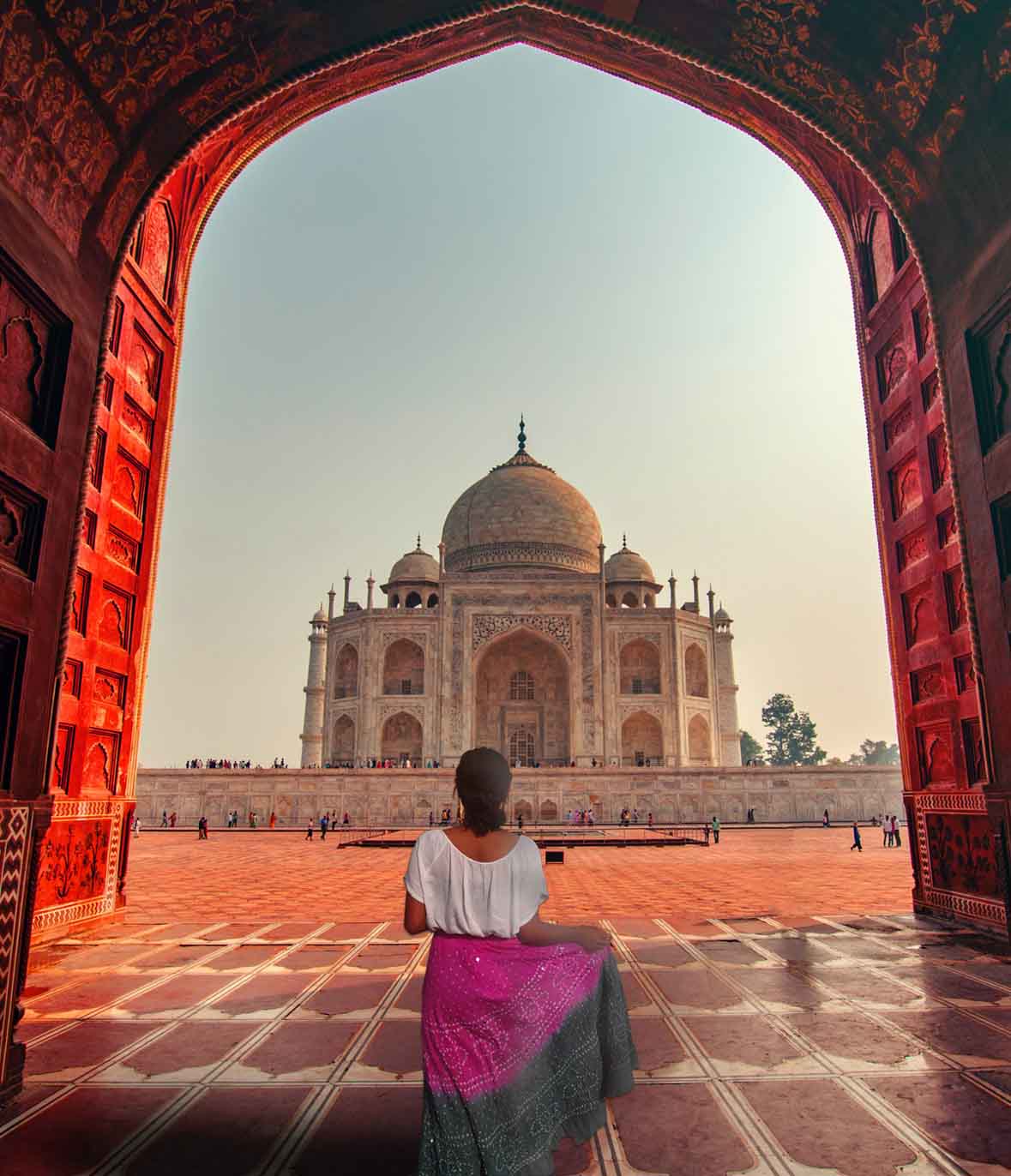 A lady twirls in front of the Taj Mahal, the UNESCO Heritage site of India during her Motorcycle tour to India on Diwali