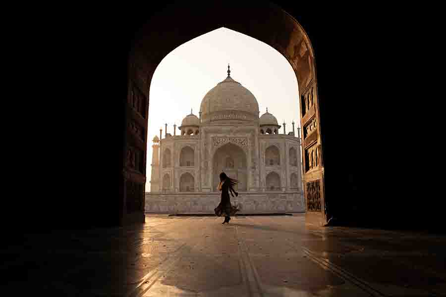 A lady swirling against the Taj Mahal I A happy dance against the beauty of makrana white Taj Mahal through the corridors